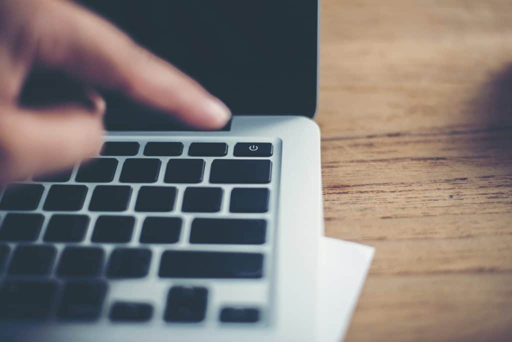 Woman hands finger point pushing into shutdown button